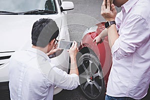 Two drivers man arguing after a car traffic accident collision and making phone call to Insurance Agent and take a photo, Traffic