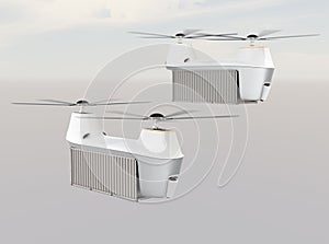 Two drones carrying cargo containers flying in the sky