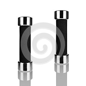 Two dumbbells on white background with reflection isolated closeup, metal barbells with black arm set, pair of fitness bar-bells