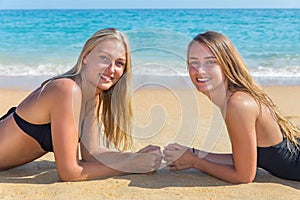 Two dutch girls lying on beach