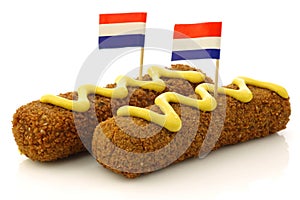 Two Dutch snacks called kroket with mustard