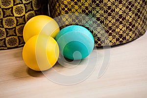 Two Easter cakes and three colored eggs, yellow and blue