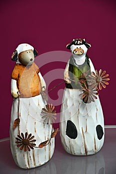 Two easter ceramic sheeps on a red background