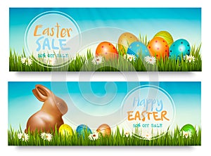 Two easter sale banners with colorful ggs in grass