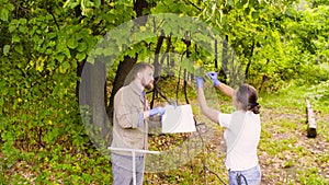 Two ecologist getting samples of foliage in city park photo