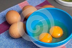 two egg yolks in a blue bowl