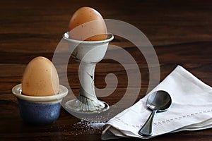 Two eggs for breakfast on a dark table
