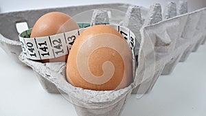 Two Eggs in Carton with Measuring Tape 2