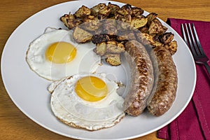 two eggs with italain sausage and home fries photo