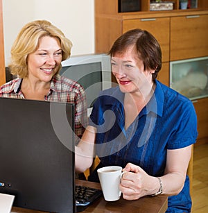 Two elderly female browsing web