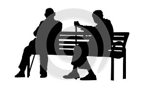 Two elderly people silhouettes sitting on a bench
