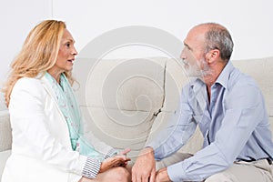Two elderly persons looking at each other