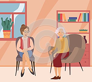 Two elderly women on a meeting at home sitting on the sofa communicating. Friendship of old people