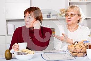 Two elderly women squabbling