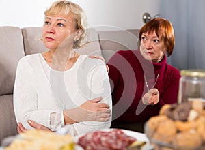 Two elderly women squabbling