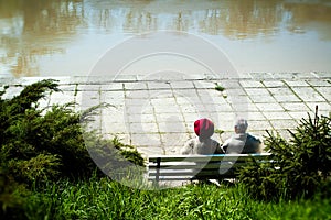 Two eldery people sitting on a bench