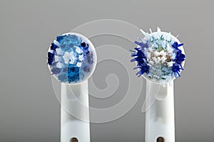 Two electric toothbrush heads compared side by side.