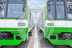 Two electric trains with green and white colour