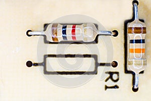 Two electrical resistors with various colored stripes.