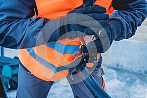 Two electrician builder workers installing high-voltage cable