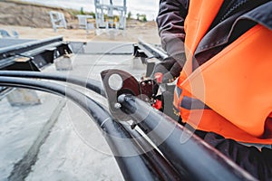 Two electrician builder workers installing high-voltage cable