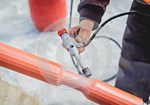 Two electrician builder workers installing high-voltage cable