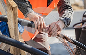 Two electrician builder workers installing high-voltage cable