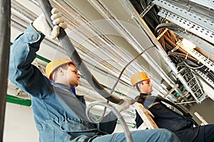 Two electrician workers at cabling photo