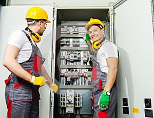 Two electricians on a factory