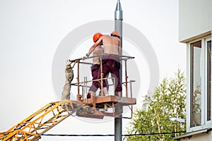 Two electricians working with naked torso