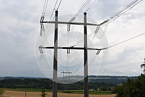 Two electricity pillars of power transmission tower of high voltage electricity viewed in summer day