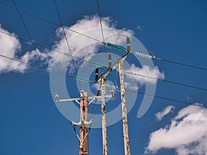 Two electricity supply pylons delivering power through the UK national grid showing power cables, isolators and other equipment.