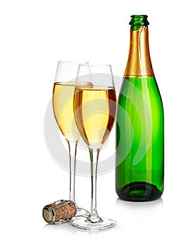 Two elegant champagne glasses on the background of green bottles close-up isolated on a white. Festive still life.