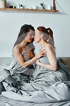 Two elegantly dressed women sitting on