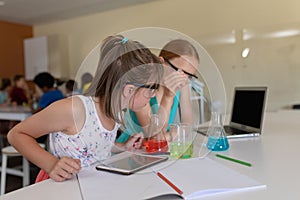 Two elementary school girls in chemistry class