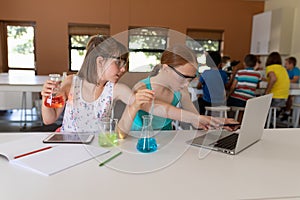 Two elementary school girls in chemistry class