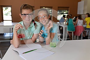 Two elementary school girls in chemistry class