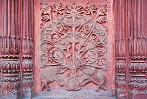 Two elephant under a tree of life. Bas-relief on the wall of an ancient temple