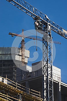 Two elevating cranes at the construction site
