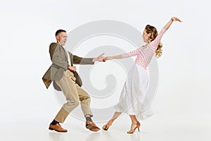 Two emotional dancers in vintage style clothes dancing swing dance, rock-and-roll or lindy hop isolated on white