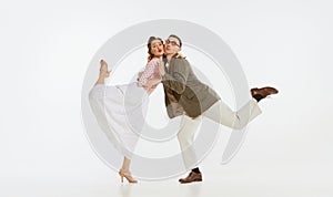 Two emotional dancers in vintage style clothes dancing swing dance, rock-and-roll or lindy hop  on white