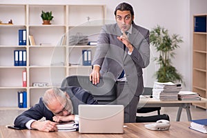 Two employees sitting at workplace