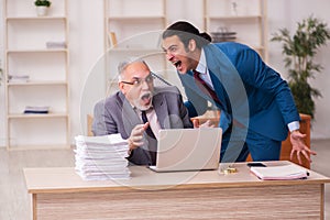 Two employees working in the office