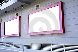 Two empty advertising billboards on the wall of building