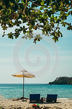 Two empty beach chairs and umbrella at a beach in Koh Kood, Thailand. Amazing scenery, relaxing beach, tropical landscape