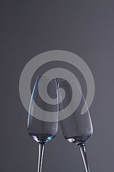 Two empty champagne glasses on a dark background