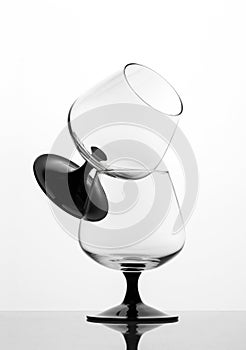 Two empty cognac glasses on white background