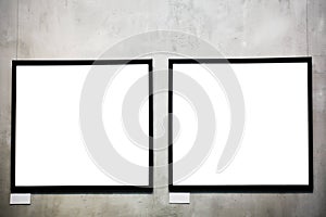 Two empty frames on cement wall