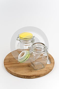 Two empty glass jars on the wooden board