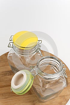 Two empty glass jars on the wooden board